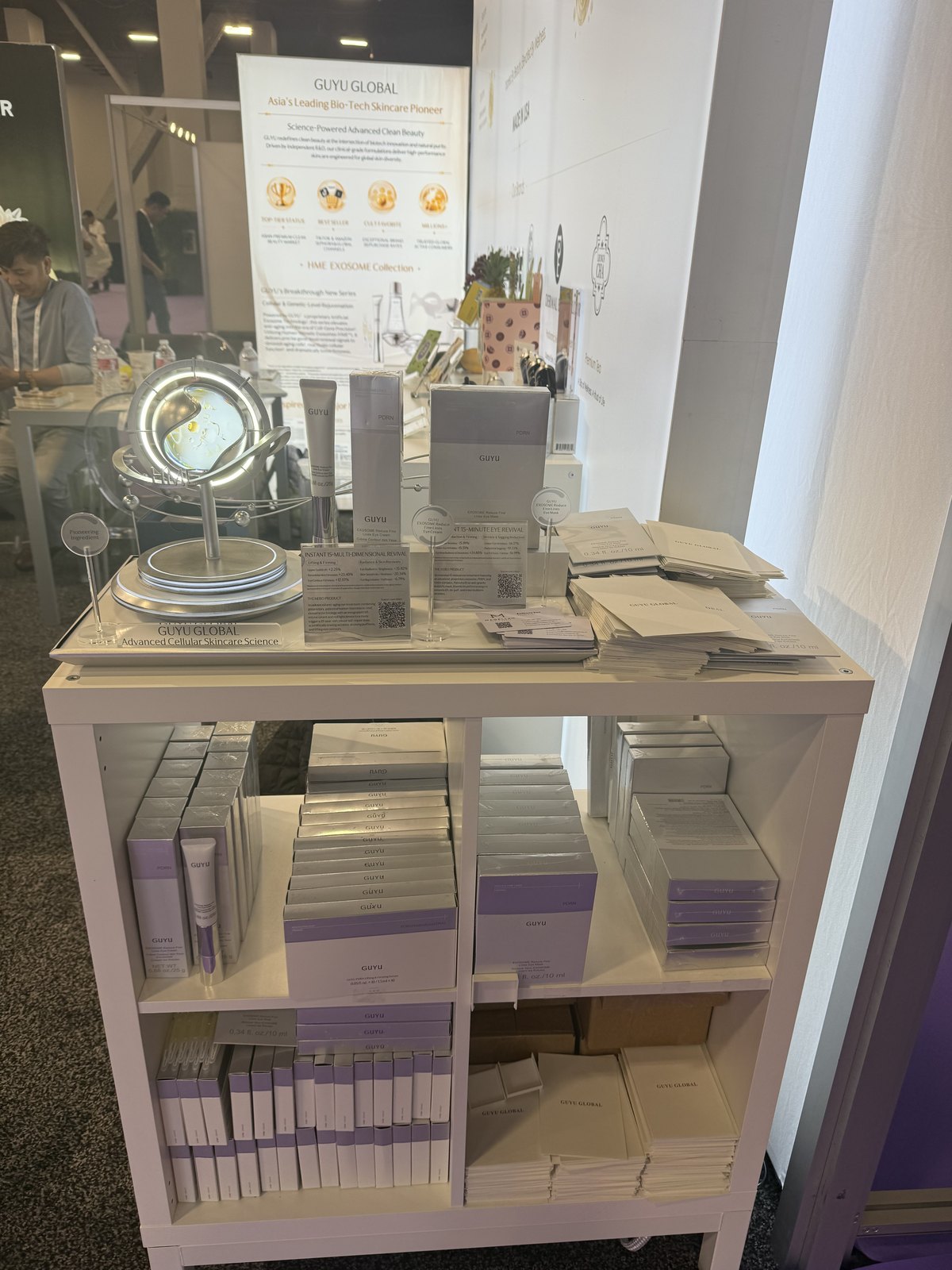 A skincare stand at Cosmoprof North America showing an exosome eye-care line with printed clinical claim cards