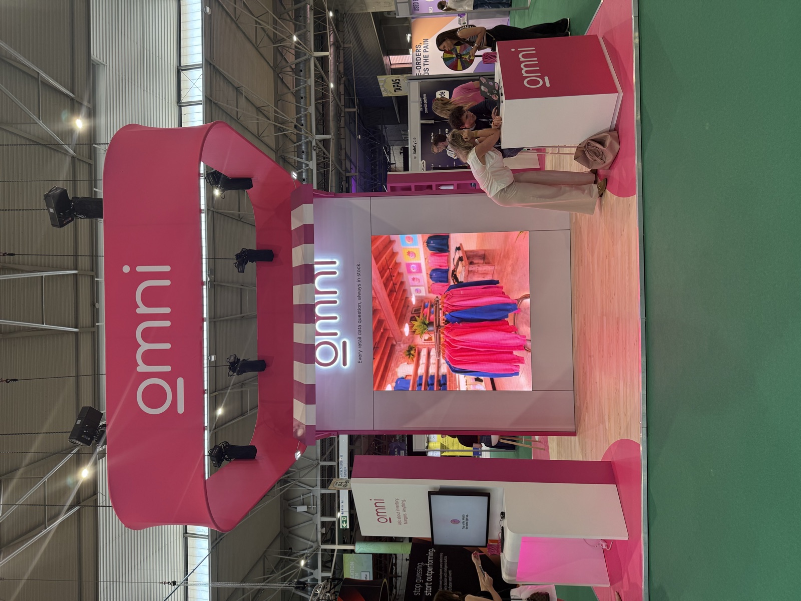 The pink Omni stand on the Shoptalk exhibition floor